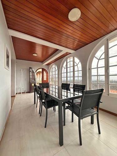 a dining room with a black table and chairs at Casa Valhalla in Funchal