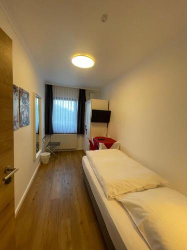a bedroom with a bed and a chair in it at Gasthaus Sonnen in Trierweiler