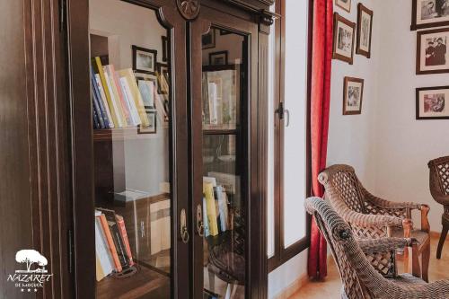 a room with a book case with books at Complejo Turístico Rural Nazaret De Moguer in Moguer