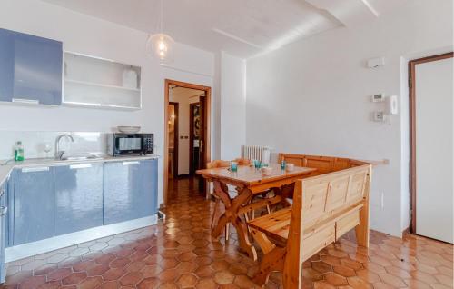 a kitchen with a wooden table and a counter top at Pet Friendly Home In Leivi With Wifi in Leivi