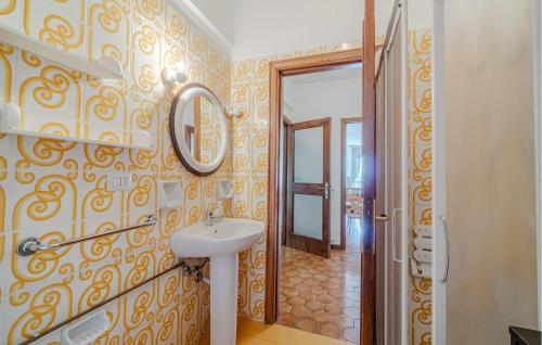 a bathroom with a sink and a mirror on the wall at Pet Friendly Home In Leivi With Wifi in Leivi