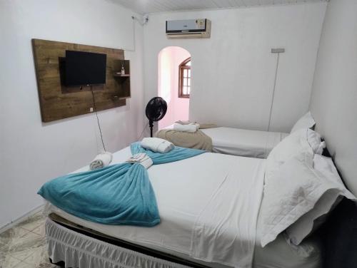 Ένα ή περισσότερα κρεβάτια σε δωμάτιο στο Pousada da Praia Frade Ar, Wi-Fi e café da manhã incluso