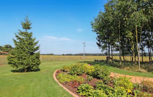 a garden with flowers and a tree in a field at Ferienhaus Viereck in Viereck