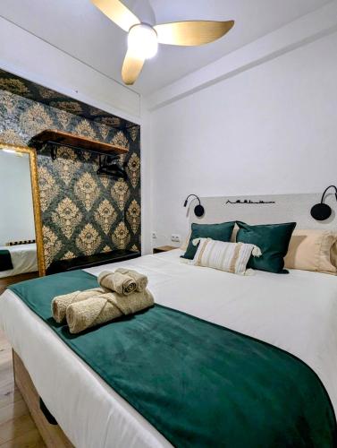 a bedroom with a bed with a towel on it at Casa San Pedro 3 in Murcia