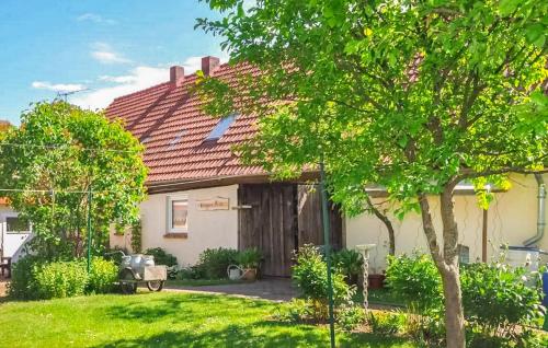 a house with a red roof and a yard at Ferienhaus Grünow in Grünow