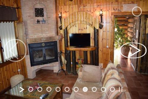 a living room with a couch and a fireplace at El Mirador de la Mancha in Villarrubia de los Ojos