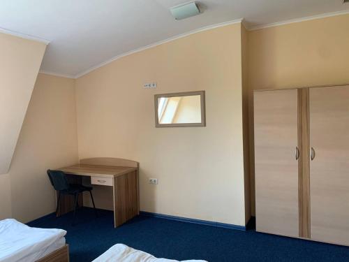 a hotel room with a desk and a bed at Budget Hotel Ekotel in Lviv