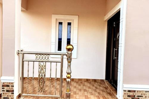 a porch with a metal railing and a door at Luxurious Home - The Paletinos in Umuahia