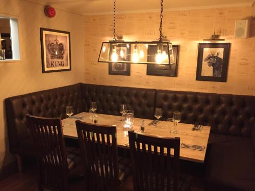 a dining room with a long table and chairs at Crown Hotel in Nantwich