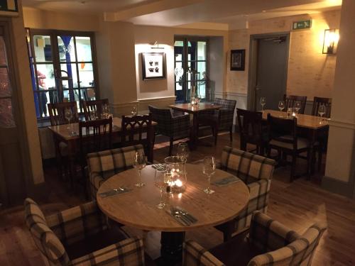 a restaurant with tables and chairs in a room at Crown Hotel in Nantwich