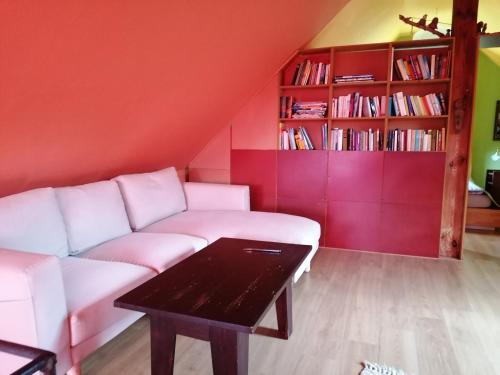 a living room with a white couch and a table at Haus 9 am Fluss in Witnica