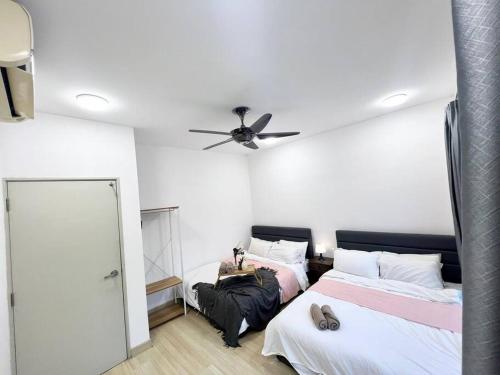 a bedroom with two beds and a ceiling fan at 16Pax House Landed Setia Alam Mall SCCC Wi-Fi TV in Shah Alam