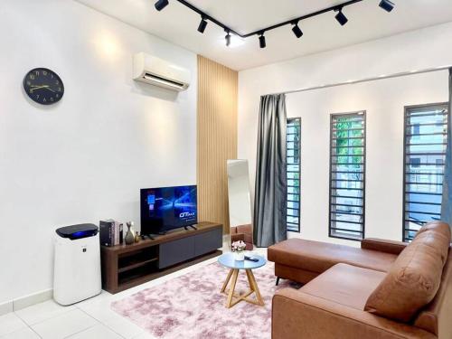 a living room with a couch and a tv at 16Pax House Landed Setia Alam Mall SCCC Wi-Fi TV in Shah Alam