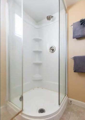 a shower with a glass door in a bathroom at Cozy Condo in Mammoth with 2 parking spots! Ski,Snowboard, Ice skate! in Mammoth Lakes