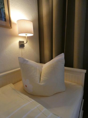 a pillow sitting on a bed in a hotel room at Stadtvilla Dessau in Dessau