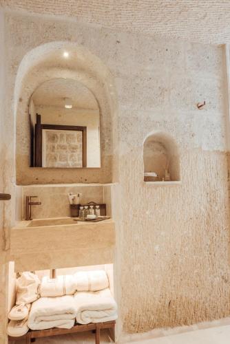 a bathroom with a sink and a mirror at Via Regia Cappadocia Hotel in Uchisar