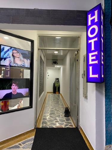 a store hallway with a neon sign on the wall at Hotel Rodmary in Saravena