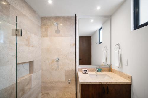a bathroom with a sink and a shower at 4 Bedroom Siela Beachfront Luxury Apartment in San Bruno