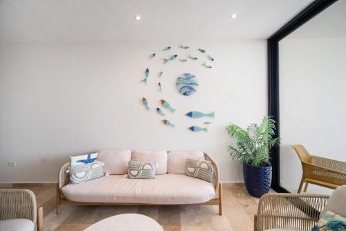 a living room with a couch and a plant at 4 Bedroom Siela Beachfront Luxury Apartment in San Bruno