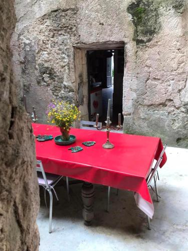 a red table with a red table cloth on it at La Maison Joly in Ménerbes