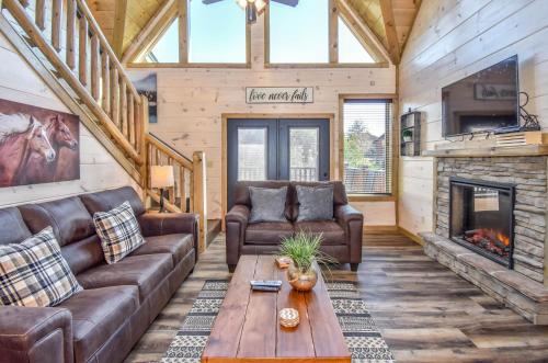 a living room with leather furniture and a fireplace at Luxury 4-BR Cabin Near Parkway and Dollywood with Game Room and Hot Tub in Pigeon Forge