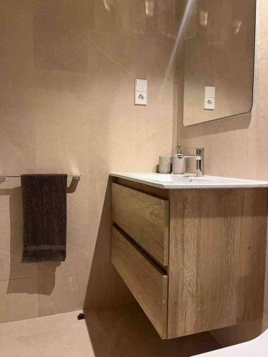 a bathroom with a sink and a mirror at Piscina con Glamour in Murcia