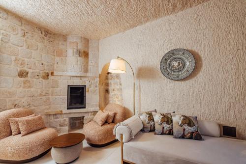 a living room with a couch and a chair at Via Regia Cappadocia Hotel in Uchisar