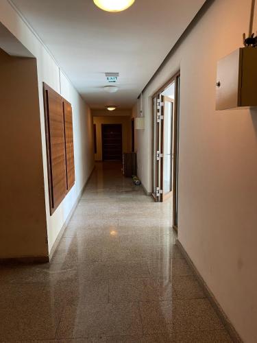 an empty hallway in a building with a hallway at Airport Haven Cozy and Convenient in Baku
