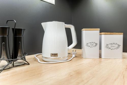 a white blender sitting on top of a wooden table at Garbo 3 bedroom Kosice Centrum Very NEW in Košice