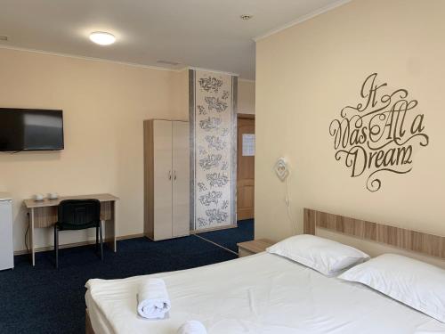 a bedroom with a bed and a sign that reads make it a dream at Budget Hotel Ekotel in Lviv