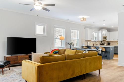 a living room with a couch and a flat screen tv at Family-Friendly 4BR with Fenced Yard & Parking in Durham