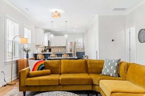 a living room with a couch and a kitchen at Family-Friendly 4BR with Fenced Yard & Parking in Durham