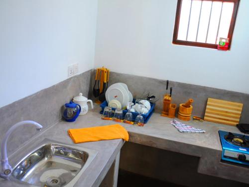 a kitchen counter top with a sink and a counter top at Pitaramba Lodge in Bentota
