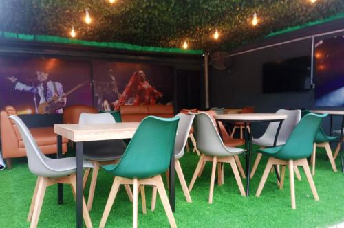 a group of chairs and a table and a stage at Ringruby Hotel, Sangotedo in Sangotedo