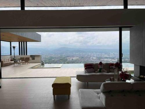 a living room with a view of a city at Luxury Villa Spectacular Views Sauna Jacuzzi BBQ in Dosquebradas