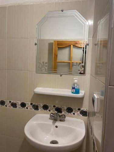 a bathroom with a sink and a mirror at tifrit maison d'hôtes-Paradise valley in Imouzzer des Ida Ou Tanane