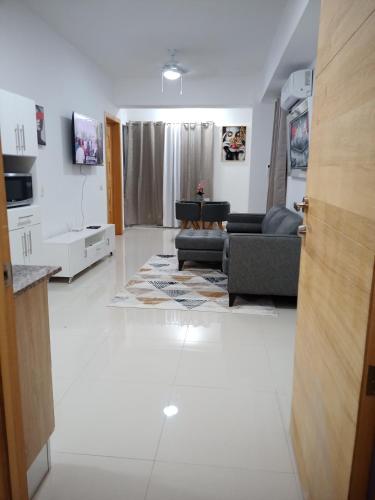 a living room with a couch and a table at The most comfortable apartment in Boca Chica in Boca Chica