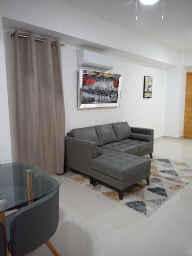 a living room with a couch and a glass table at The most comfortable apartment in Boca Chica in Boca Chica