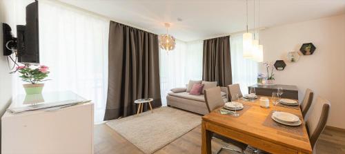 a living room with a table and a couch at Grimming Lodge by keyone in Tauplitz