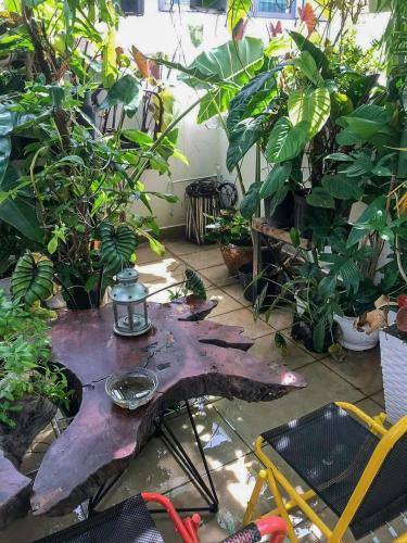 a patio with a table with plants and a light on it at Amango Dorm in Ho Chi Minh City