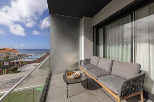 a living room with a couch and a view of the ocean at Coastal Sea Jewel in Nazaré