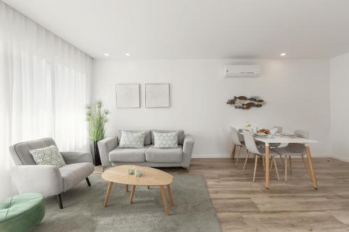 a living room with a couch and a table at Coastal Sea Jewel in Nazaré