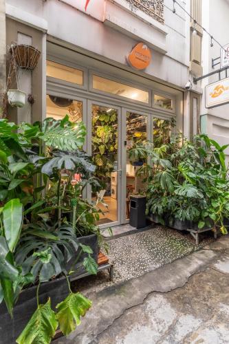 a store front with plants in front of it at Amango Dorm in Ho Chi Minh City