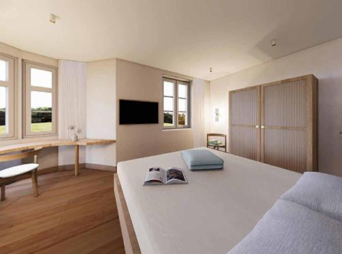 a large bedroom with a large bed and a desk at Gartenvilla in Marktheidenfeld