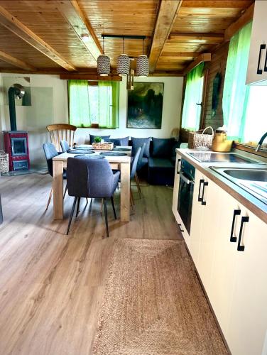 a kitchen and living room with a table and a dining room at Apartma Dobnik in Mozirje