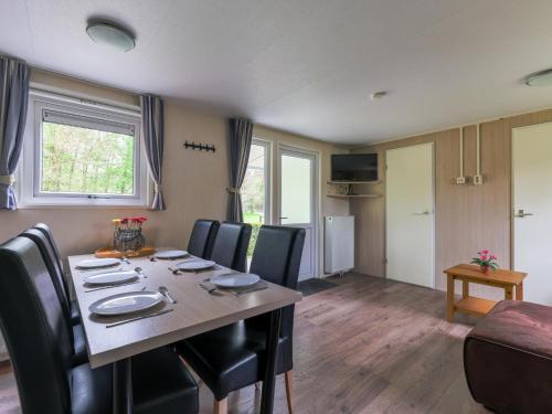 a dining room with a table and chairs at Easy Chalet in Vessem