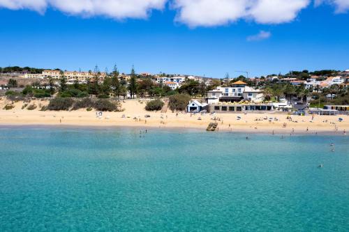 an aerial view of a beach with people in the water at Fontinha by An Island Apart in Porto Santo