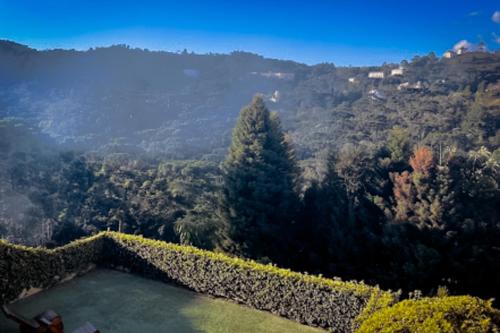 a view of a mountain with a pool of water at VELINN Pousada Casa de Campos Mountain House in Campos do Jordão