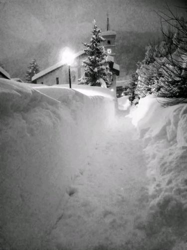 a snow covered driveway with a house and trees at B&B L'Abric - centro storico di Limonetto in Limone Piemonte