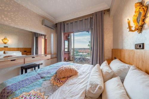 a bedroom with a large bed with a large window at 22 - Grand Palace Marrakesh in Marrakech